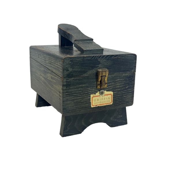 Vintage Griffin Shinemaster Wooden Shoe Shine Box With Brass Clasp and Footrest. A vintage dark wood shoeshine case with a brass clasp and a brass label reading 'Griffin Shinemaster', set on a textured white surface against a light gray background.