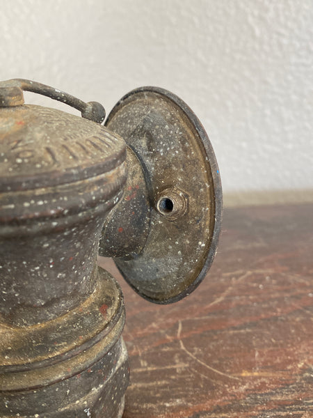 Antique Auto Lite Miners Lamp, close up of screw hole.