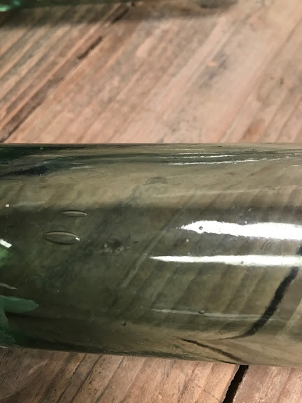 antique torpedo bottle close up bubbled glass
